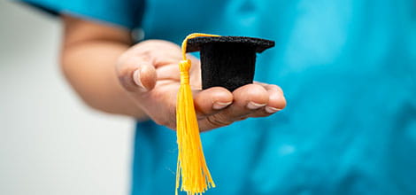 new doctor holding graduation hat